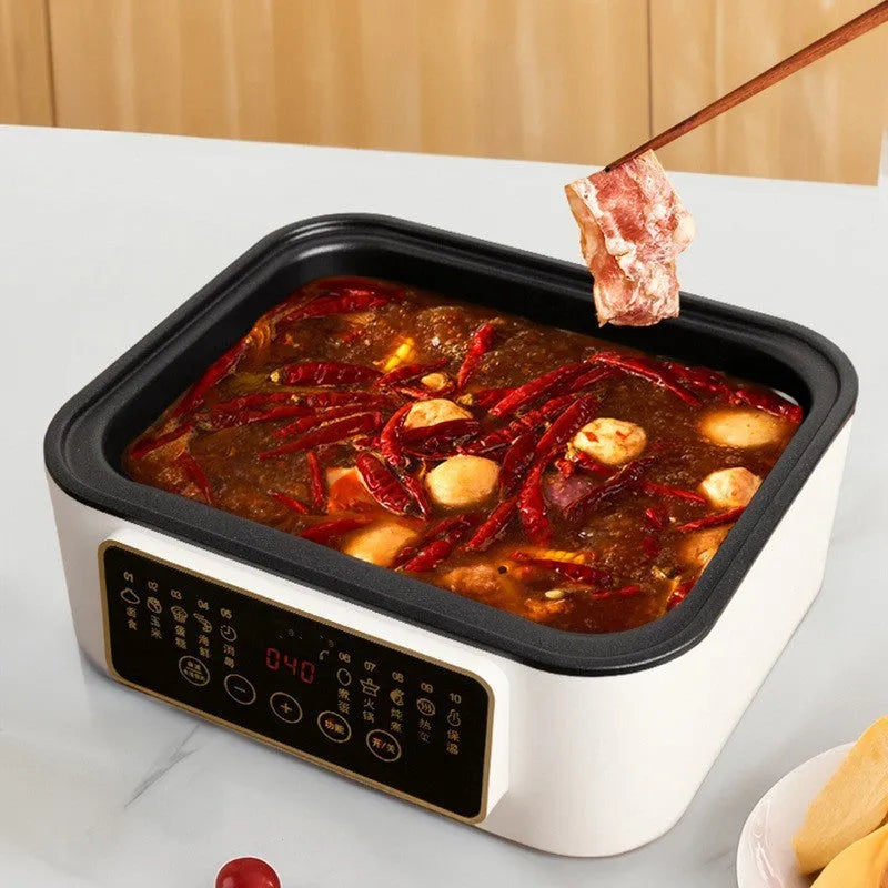 Stainless steel electric food steamer with digital display and steaming rack on a kitchen counter.