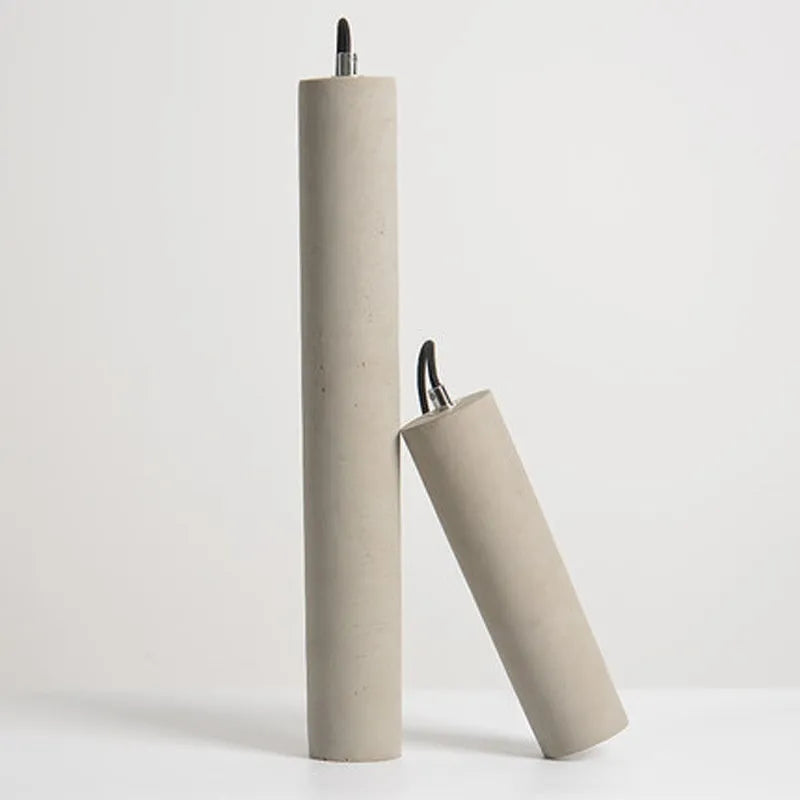 Cement industrial droplight in glossy finish on a wooden bedside table