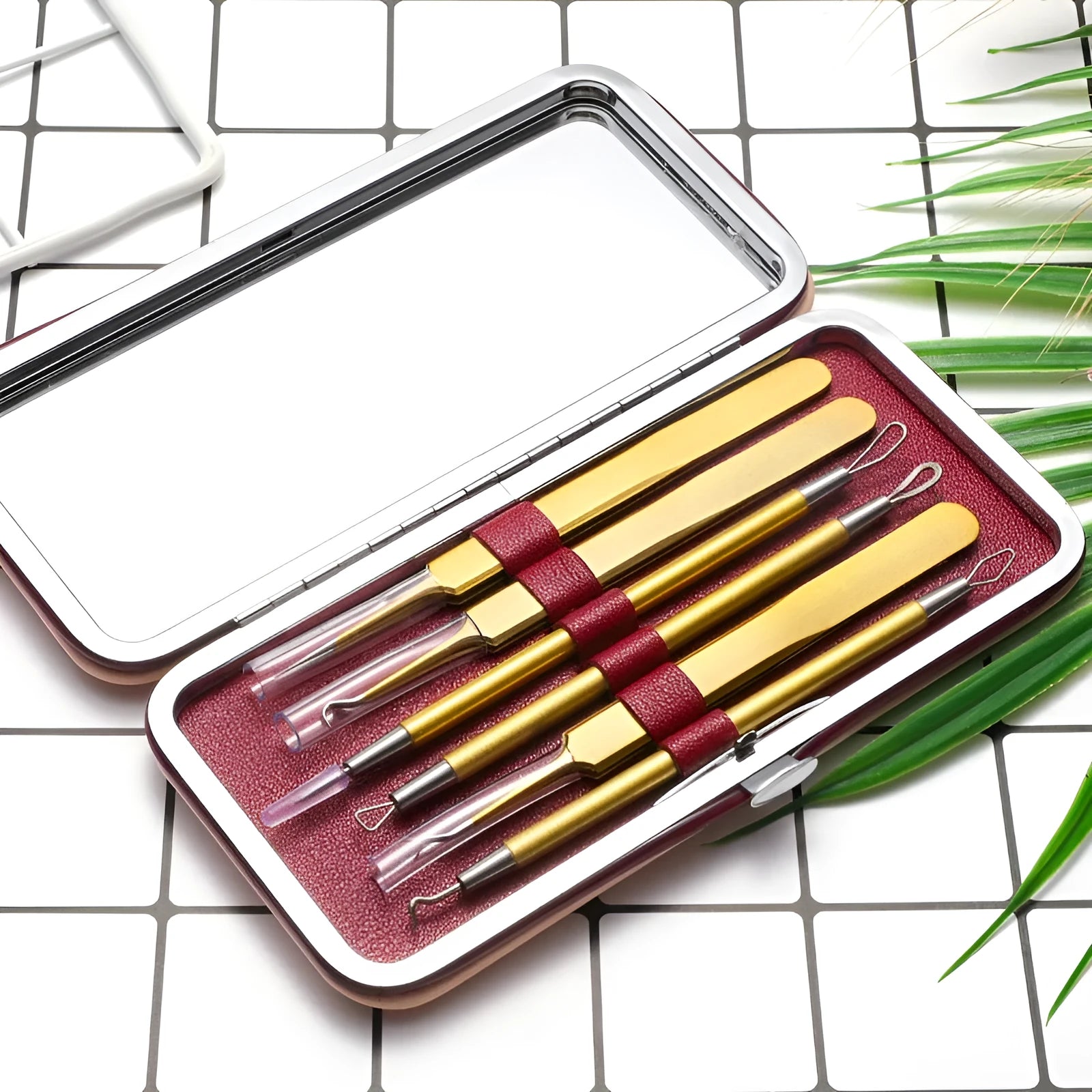 Six-piece stainless steel acne remover tool set in rose gold finish