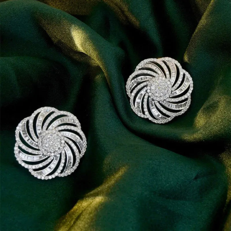 Copper geometric line flower design earrings with inlaid zircon in white gold colour on a neutral background
