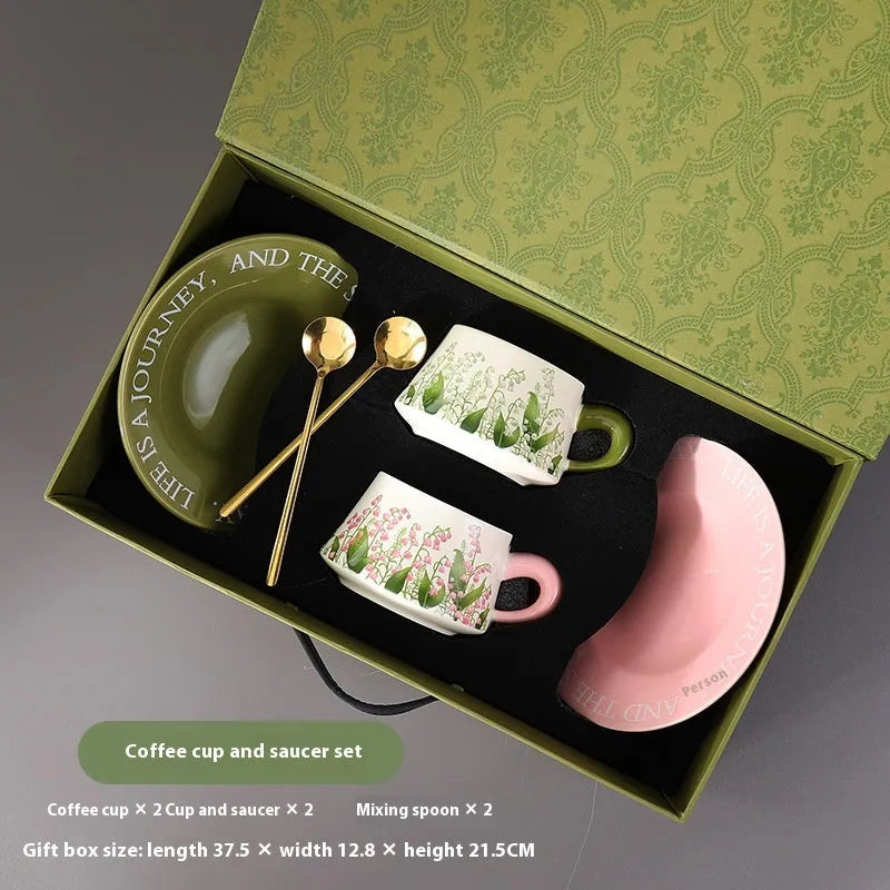 Ceramic coffee cup set with two mugs, saucers, and spoons in Campanula or Lanling Grass designs