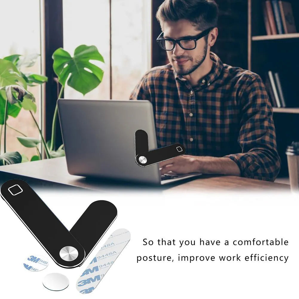 Black magnetic laptop phone holder clip attached to a monitor with a smartphone mounted.