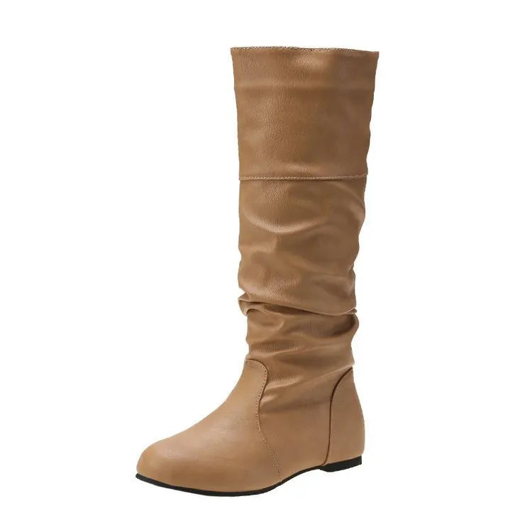Women's black flat slip-on boots with round toe and high shaft on a white background.