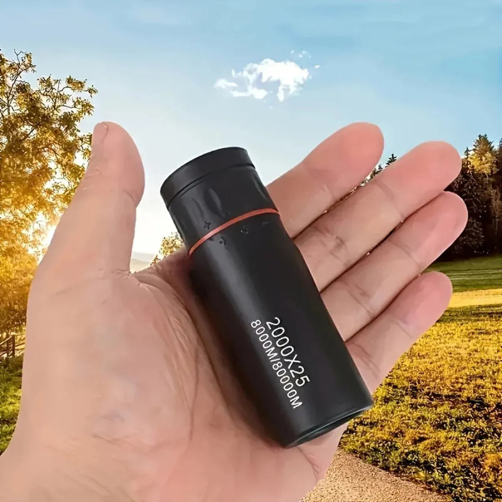 Black monocular telescope with rubber exterior and mobile phone attachment holder