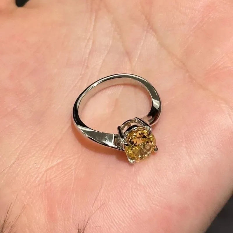 Women's copper ring with a bright yellow crystal sugar finish on a finger.