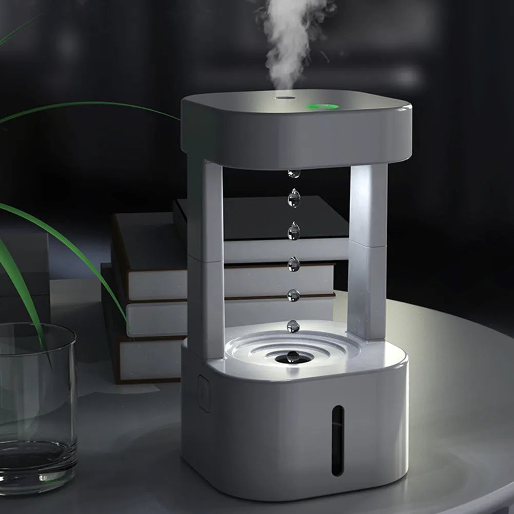 Anti-gravity water drop humidifier with coloured lights on a desk, showing water droplets appearing to float.