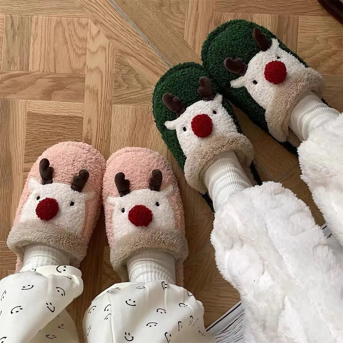 Women's Christmas elk plush slippers with decorative antlers and non-slip PVC soles in brown, green, and pink colours