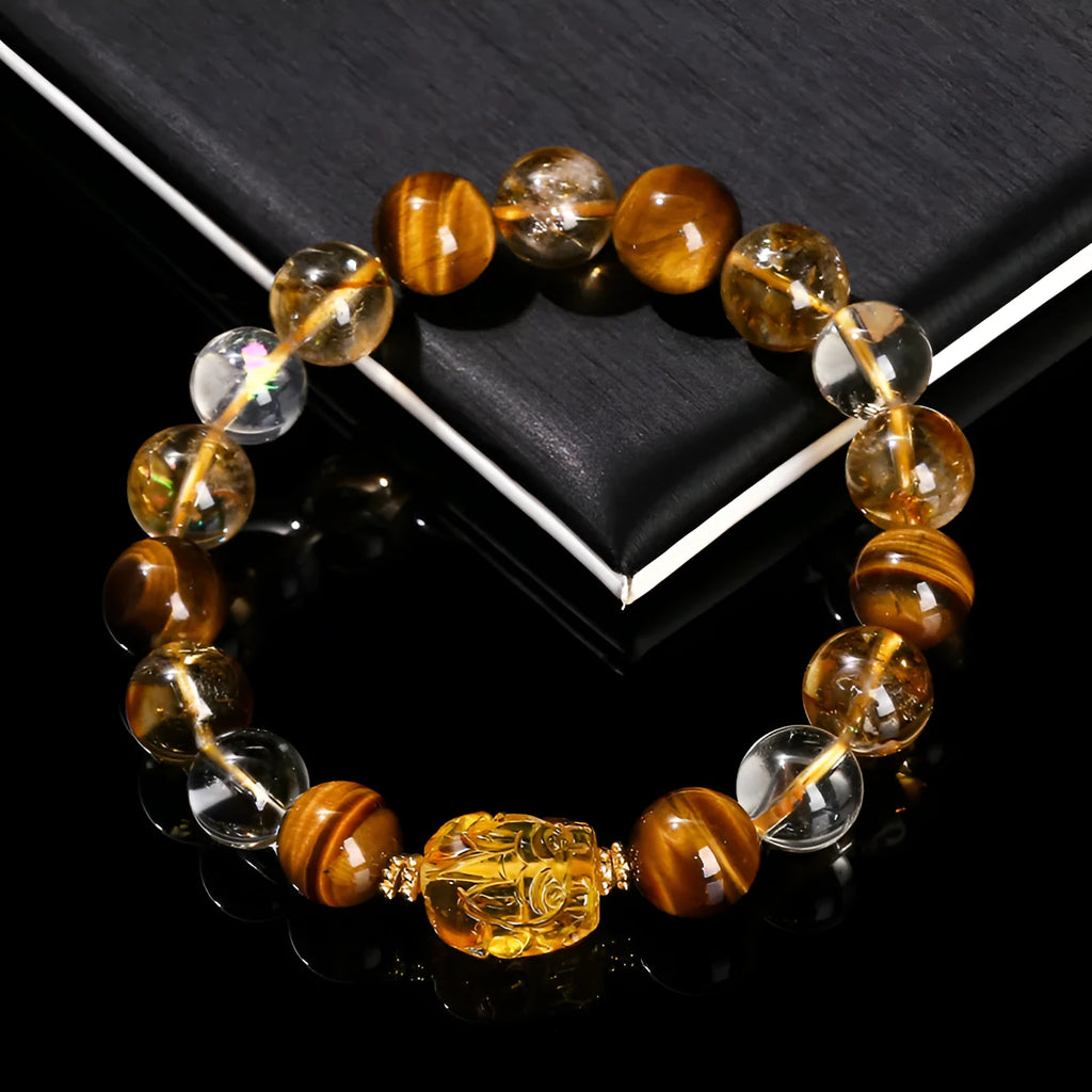 Close-up of a yellow tiger's eye and citrine gemstone bracelet with 10mm round beads and a steel clasp.