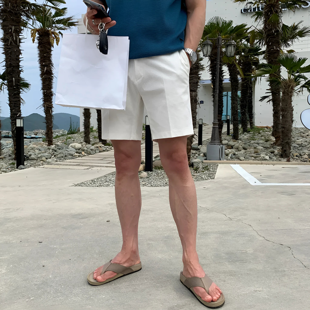 Man wearing loose straight-leg casual shorts in solid khaki colour