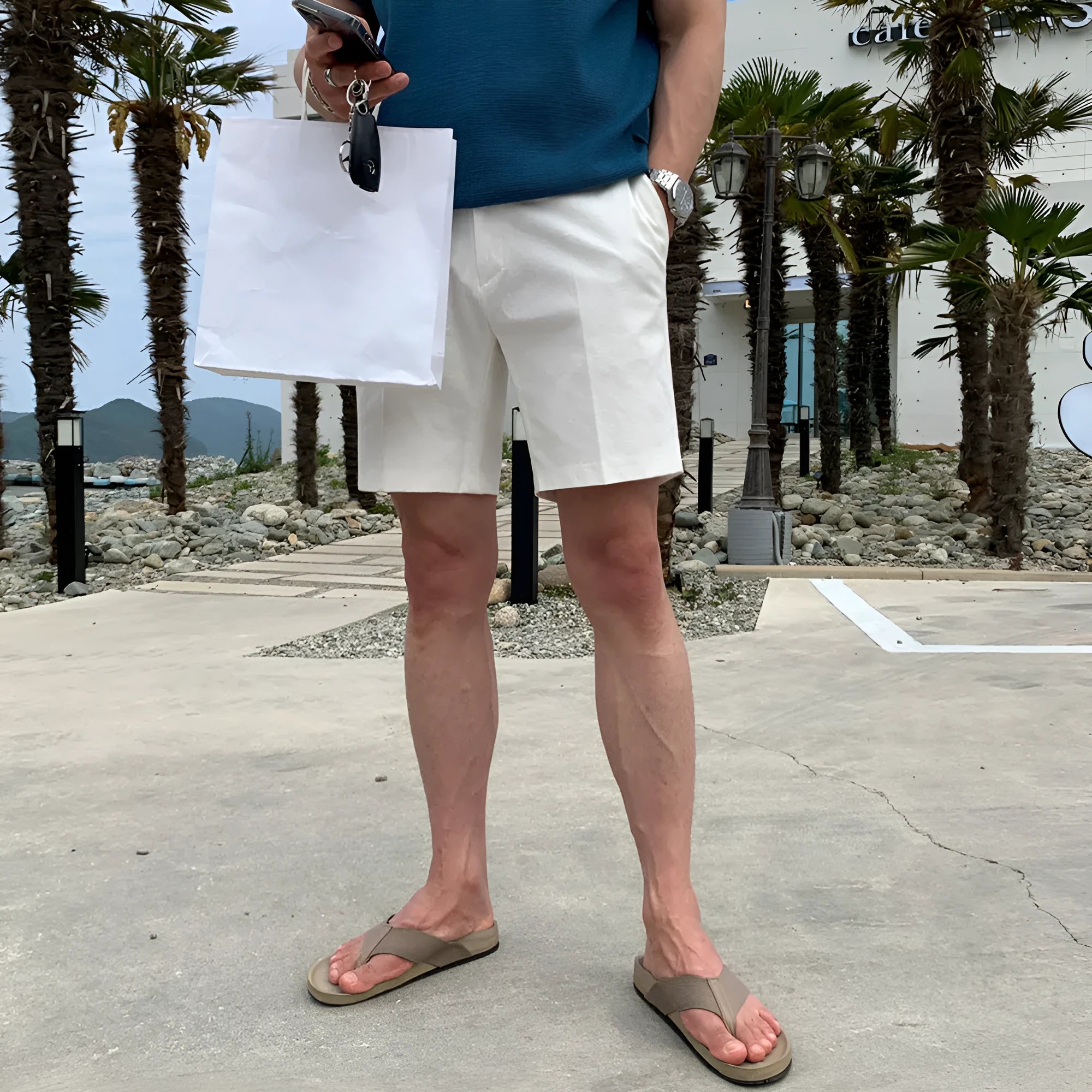 Man wearing loose straight-leg casual shorts in solid khaki colour