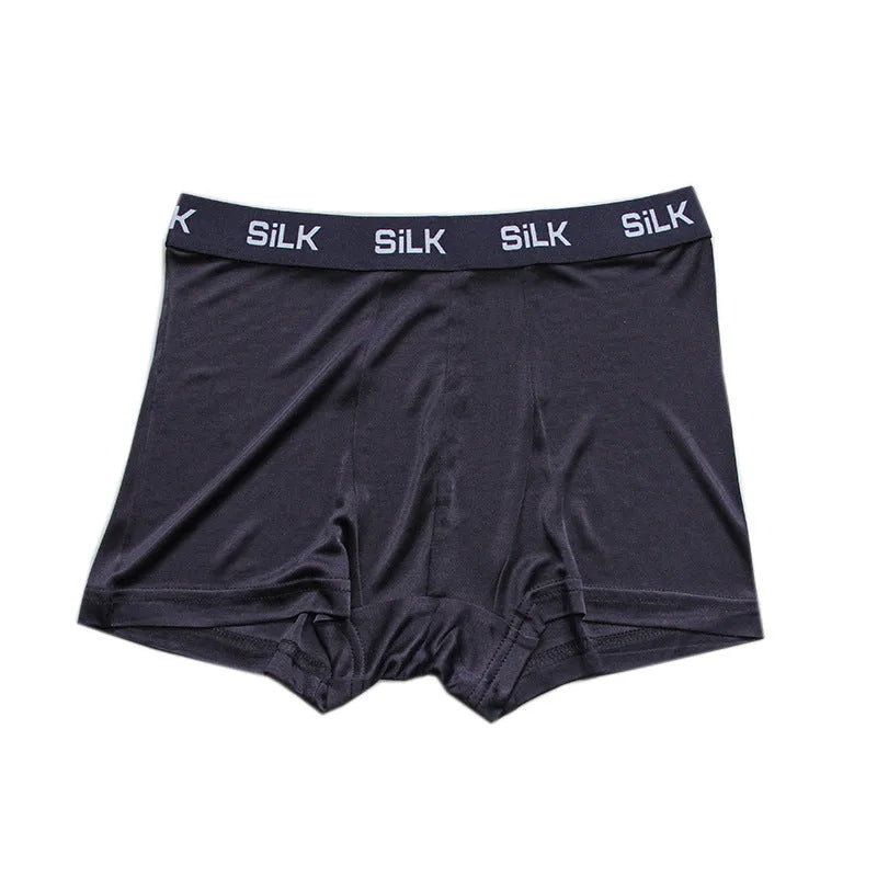 Men's loose fit silk shorts in navy blue on a mannequin, showing mid waist and casual cut