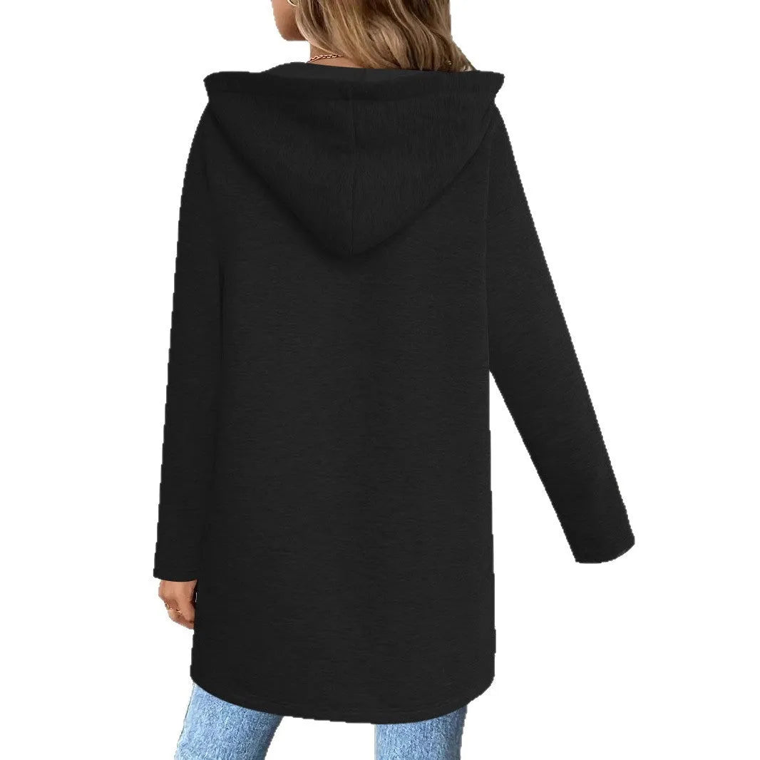 A woman wearing a loose grey mid-length cardigan coat with pockets, casual style.