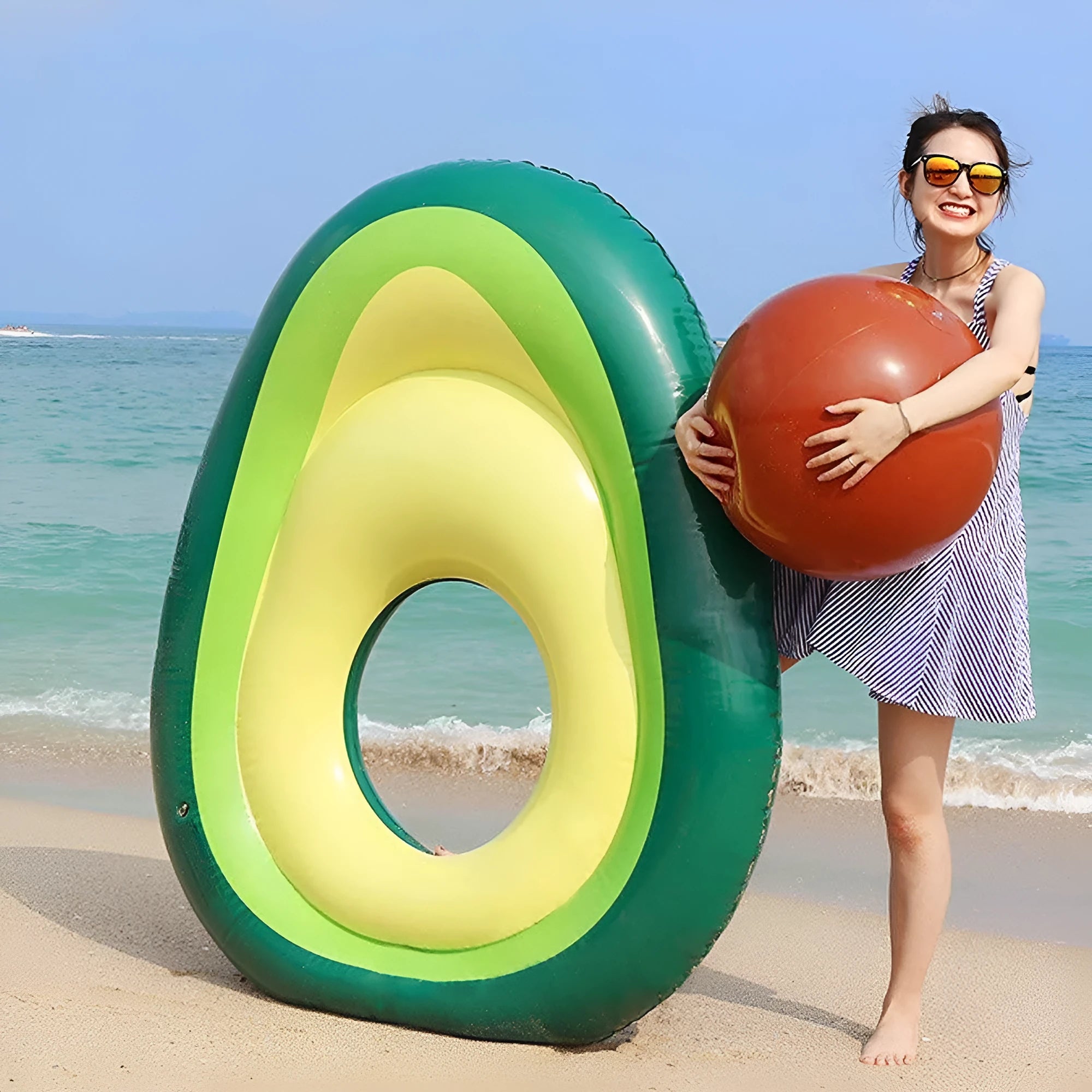 Green avocado-shaped inflatable pool float with dimensions 169cm by 130cm.