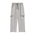 Men's loose-fit nylon casual trousers in black, grey green, or greige, with adjustable split and breathable fabric.