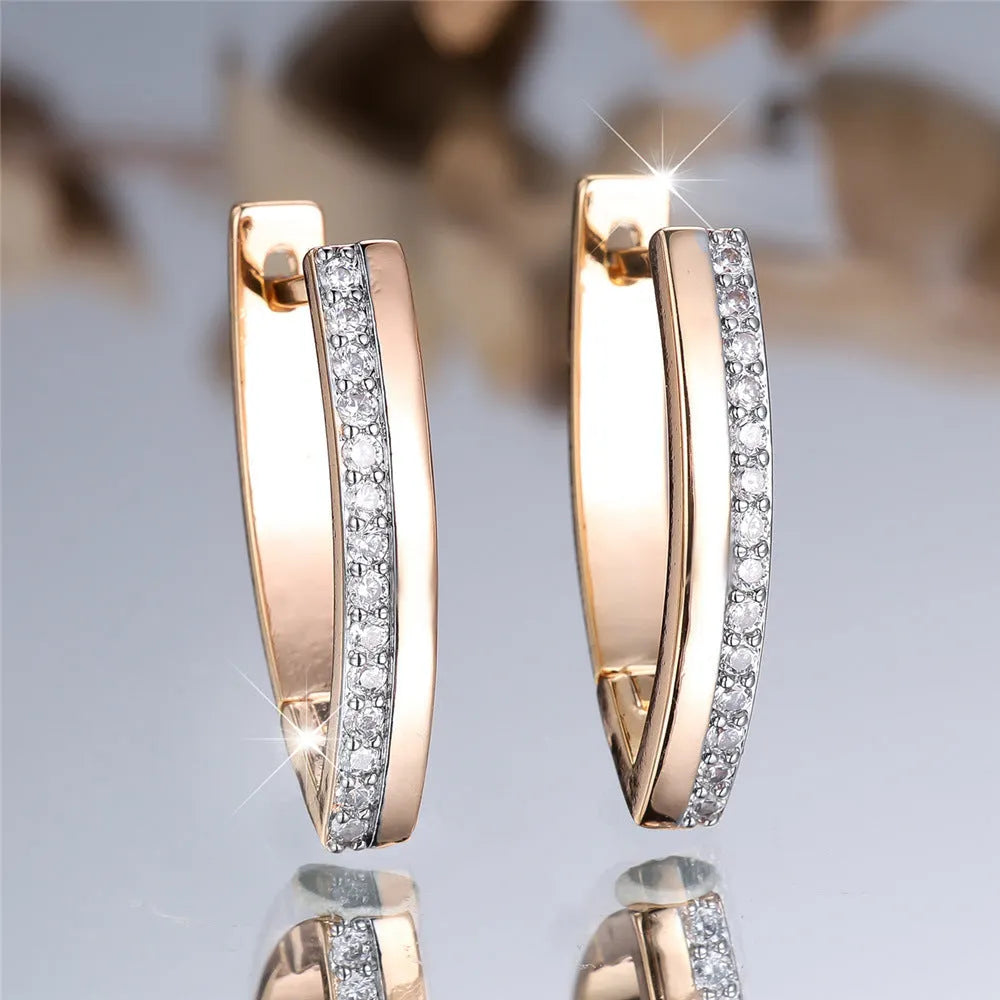 Close-up of women's geometric V-shaped champagne gold ear clips with a clip-on back.