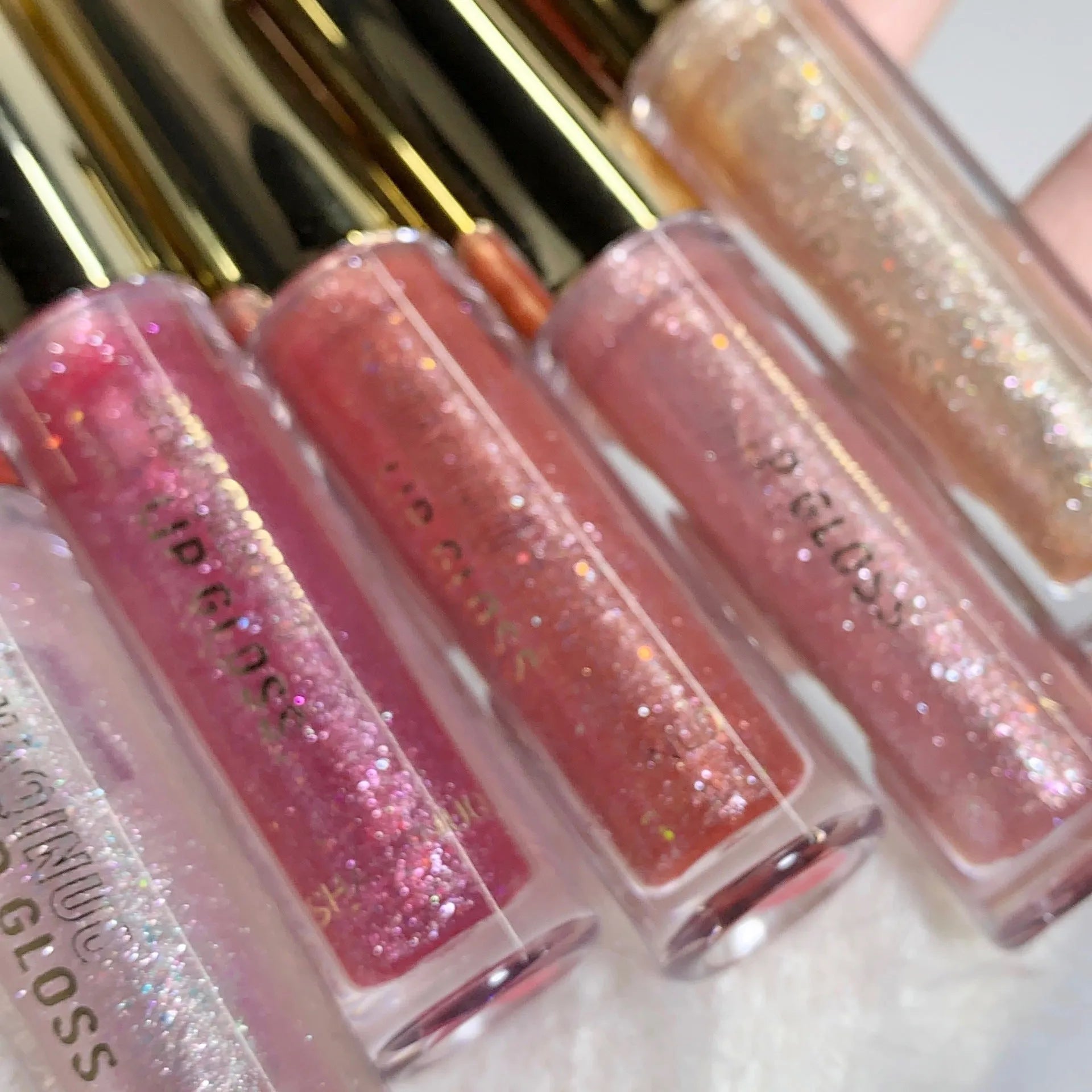 Shanuo Flash Lip Gloss in five colours: cherry blossom pink, gold flash, peach, purple, and berry red.