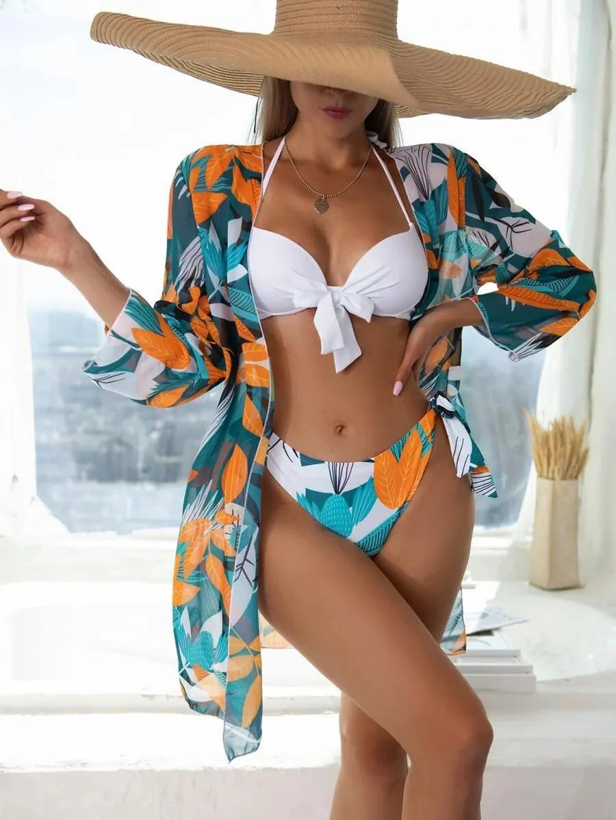 Women's three-piece bikini swimsuit set with mesh panels and matching beach coat in a colour option.