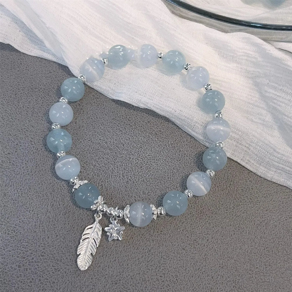 Small white girl crystal bracelet with feather XINGX blue moonlight colour and eight awn star details