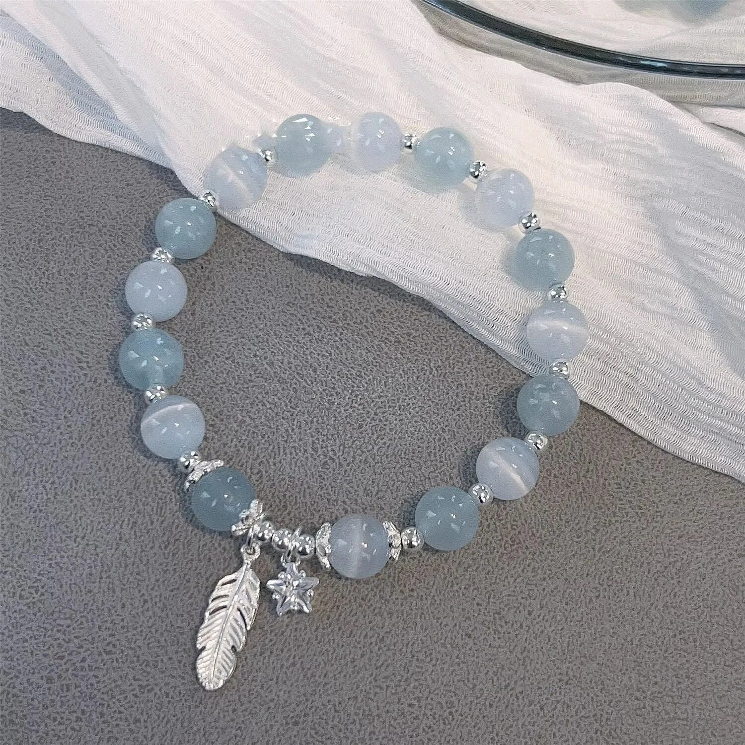 Small white girl crystal bracelet with feather XINGX blue moonlight colour and eight awn star details