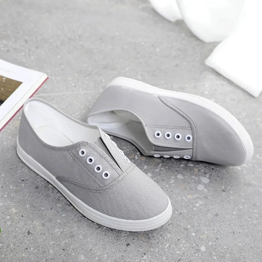 A pair of low-top canvas casual shoes in black with a flat plastic sole