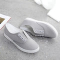 A pair of low-top canvas casual shoes in black with a flat plastic sole