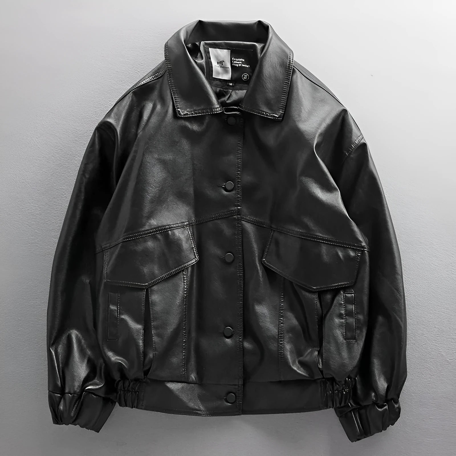 Men's black PU leather biker jacket loose street style with padded design on a model