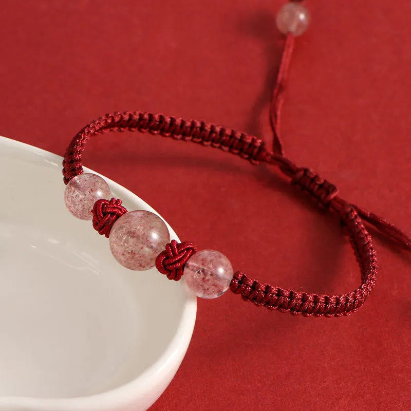Woven red rope bracelet with strawberry quartz beads and alloy clasp