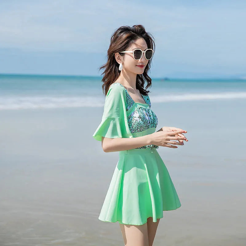 Women's blue and green seaside floral print one-piece swimsuit on size chart