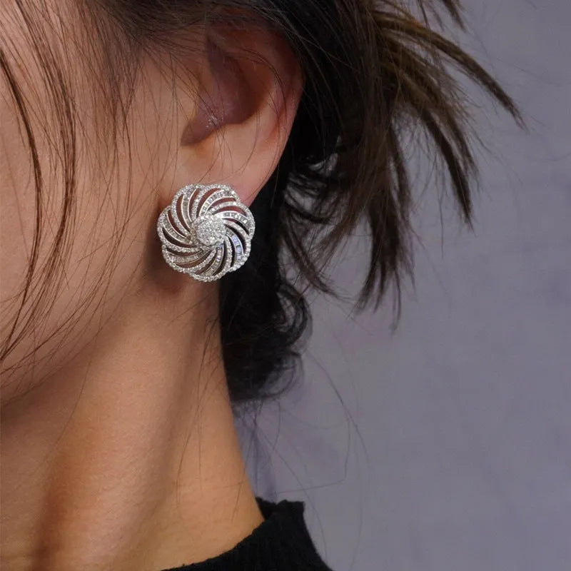 Copper geometric line flower design earrings with inlaid zircon in white gold colour on a neutral background