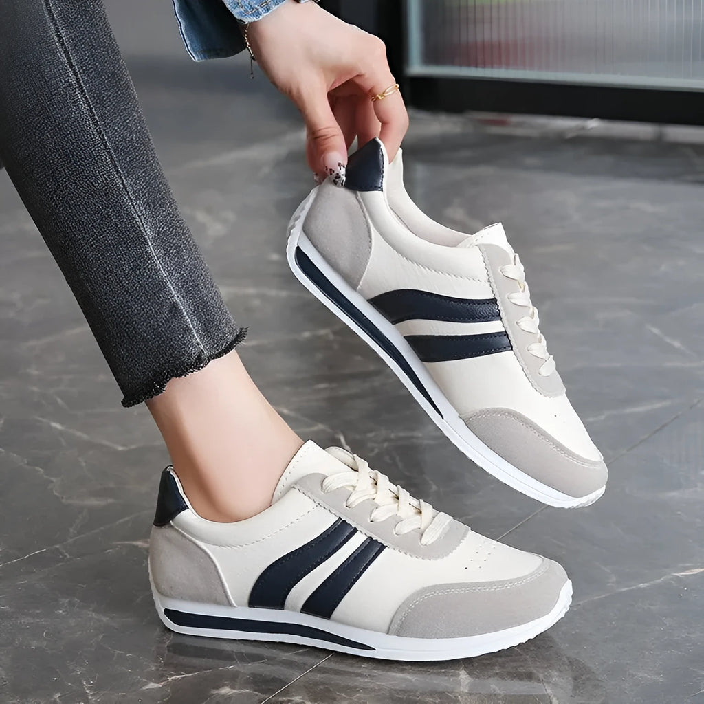 Blue lace-up leisure sneaker with soft bottom and rubber sole on white background
