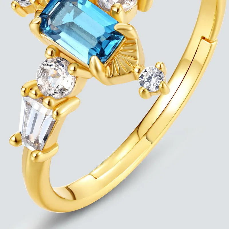 S925 sterling silver adjustable ring with London blue topaz colour, 10K gold electroplated finish, and geometric quadrilateral shape
