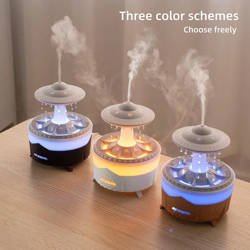 White cloud-shaped UFO raindrop humidifier diffuser with coloured night light on a wooden table.