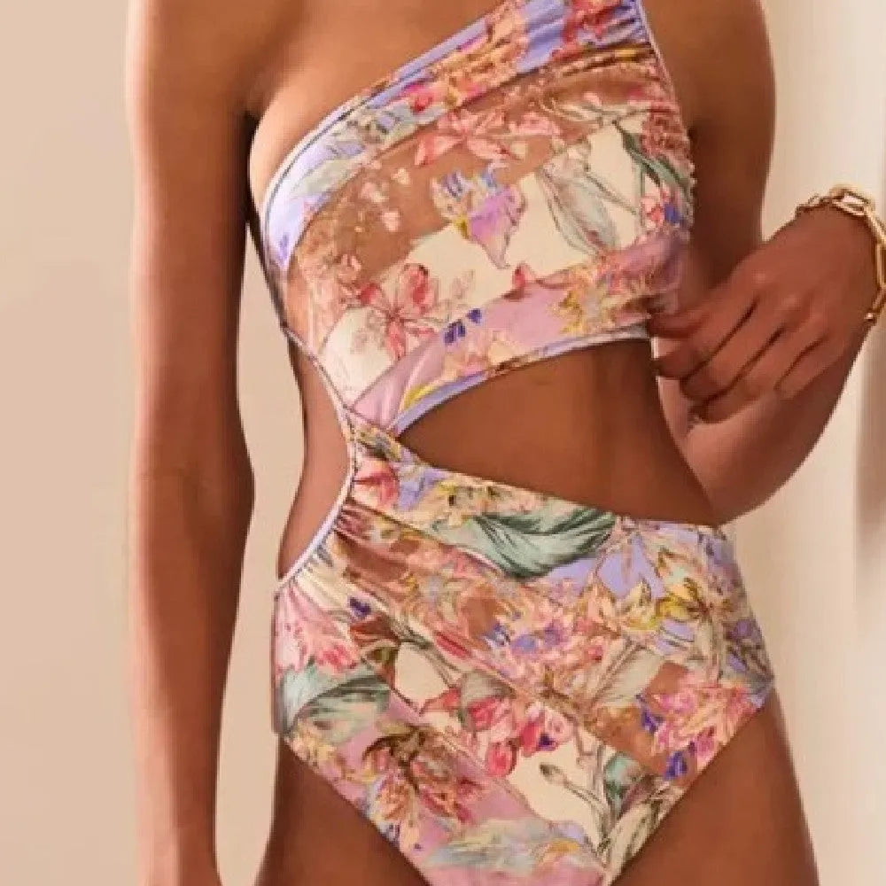 Rose gold patterned women's one-piece swimsuit on a hanger.