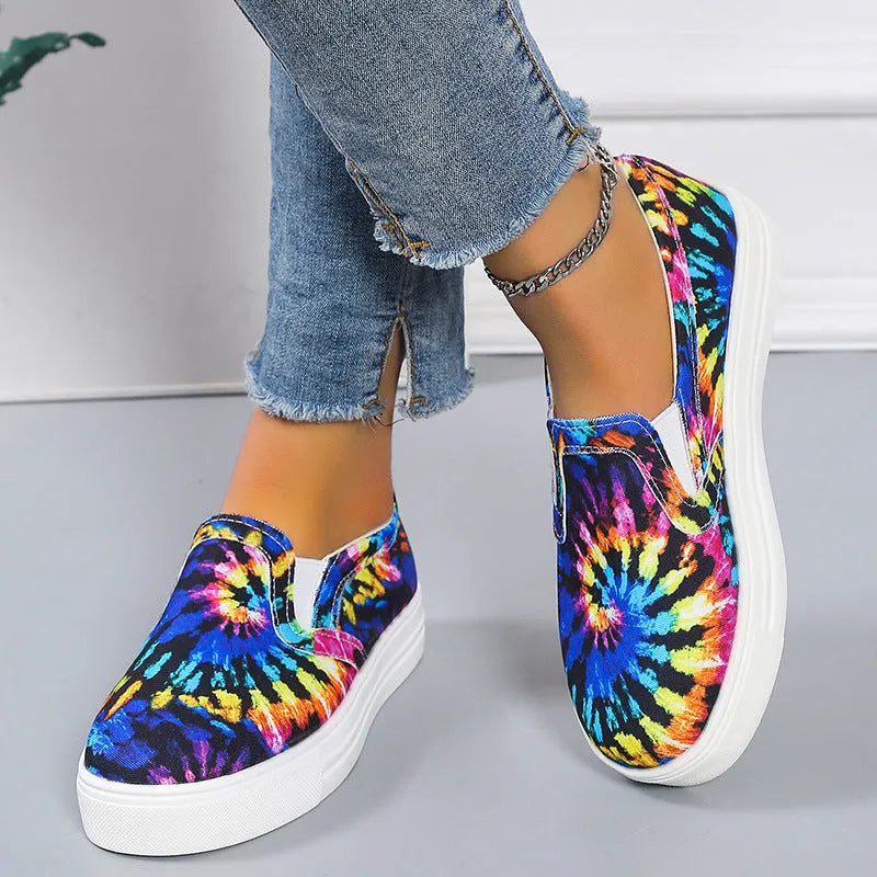 Women's low-top canvas slip-on shoes in colour matching pattern with rubber sole.