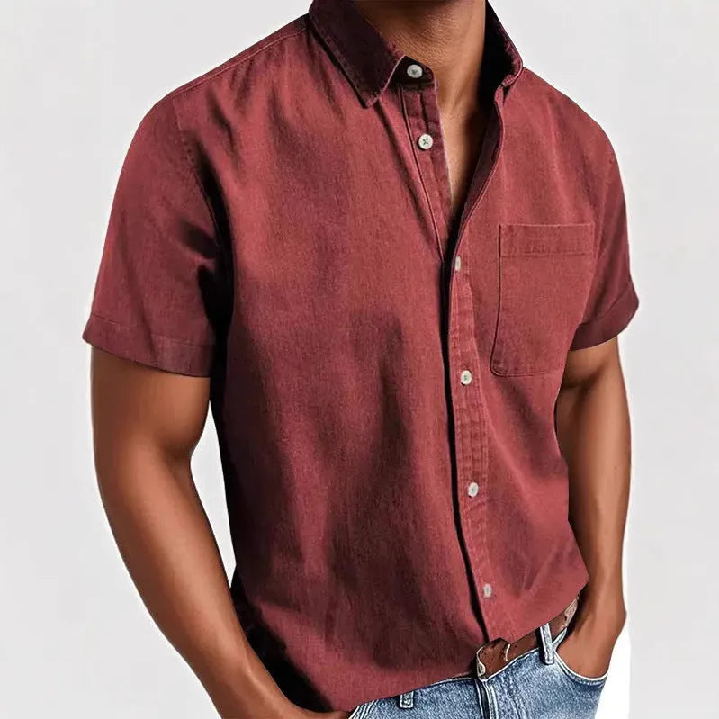 Men's solid colour short sleeve polo shirt with a chest pocket and polo collar on a hanger.