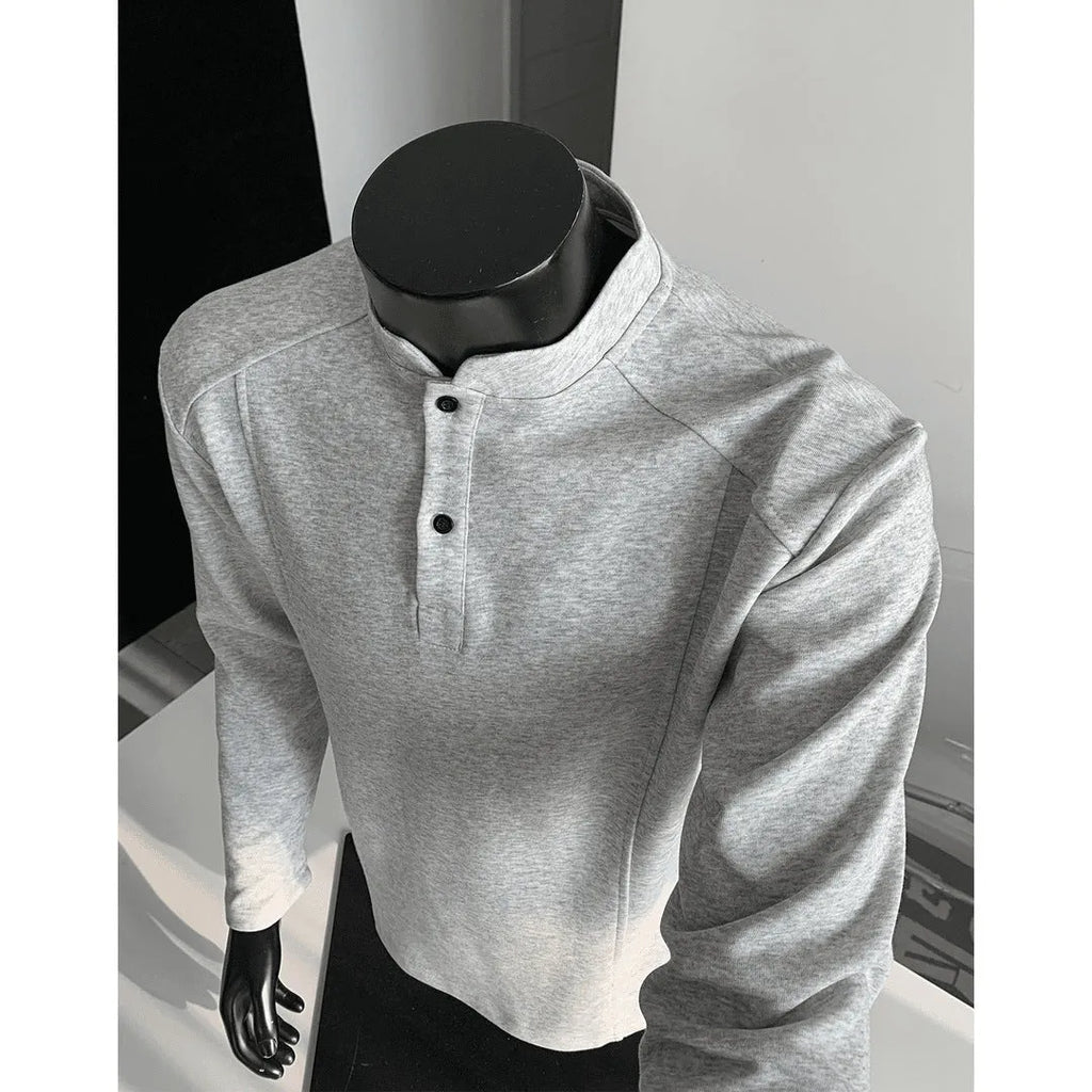 Men's grey polo shirt with patchwork detailing on shoulders and stand-up collar