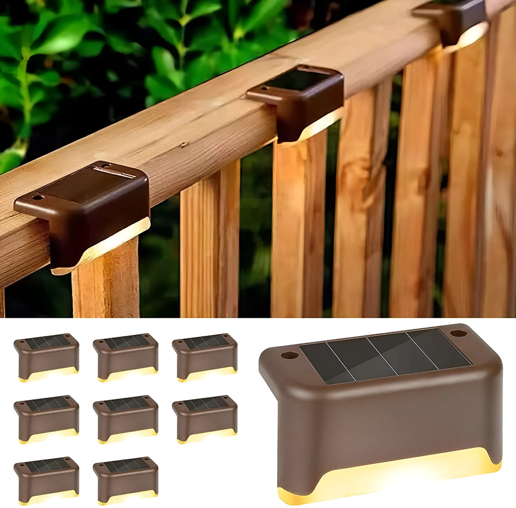 Set of four brown solar step lights with warm LED glow mounted on outdoor wooden stairs