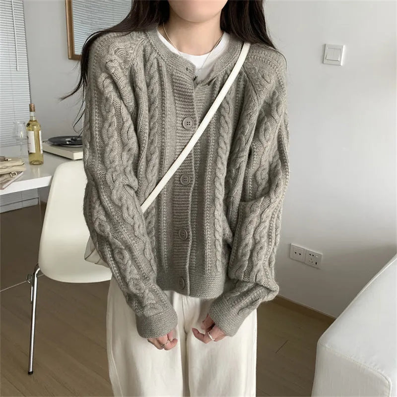 Women's loose-fit twist knit cardigan in solid colour with button front on a model