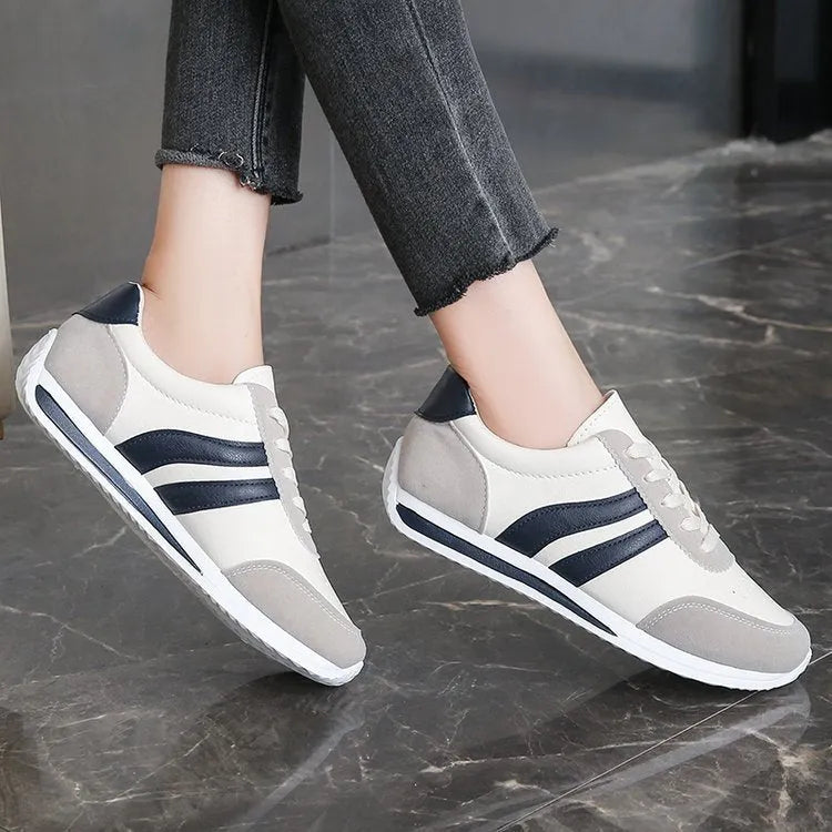 Blue lace-up leisure sneaker with soft bottom and rubber sole on white background