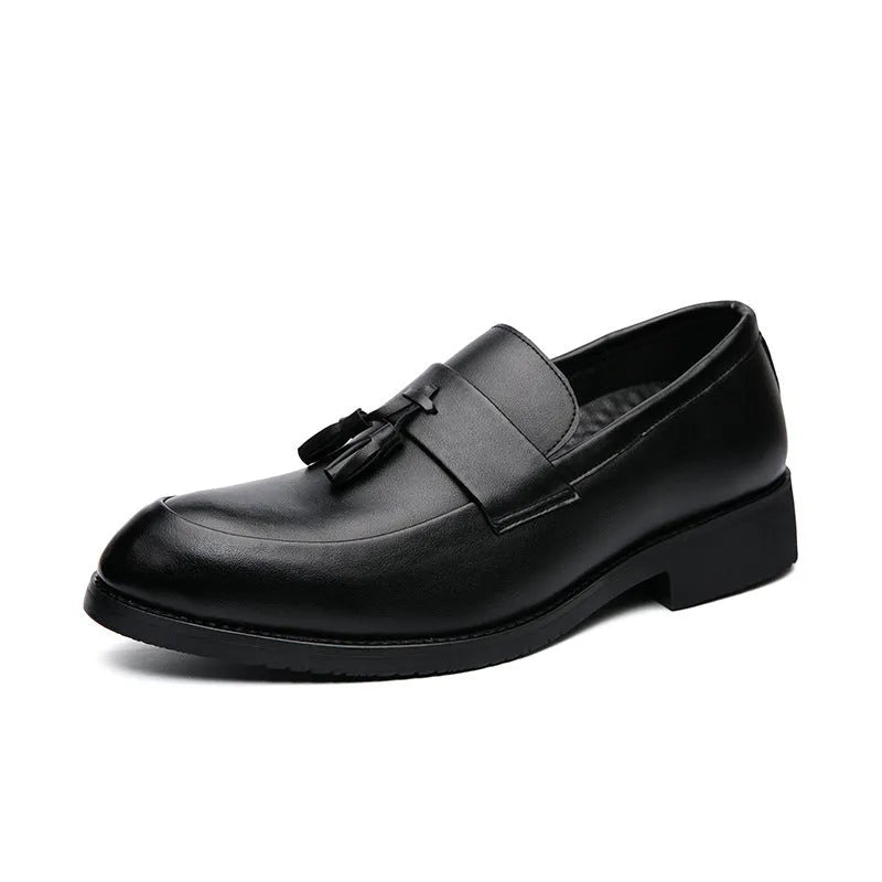 Men's black slip-on business casual shoe with tassel detail and rubber sole.