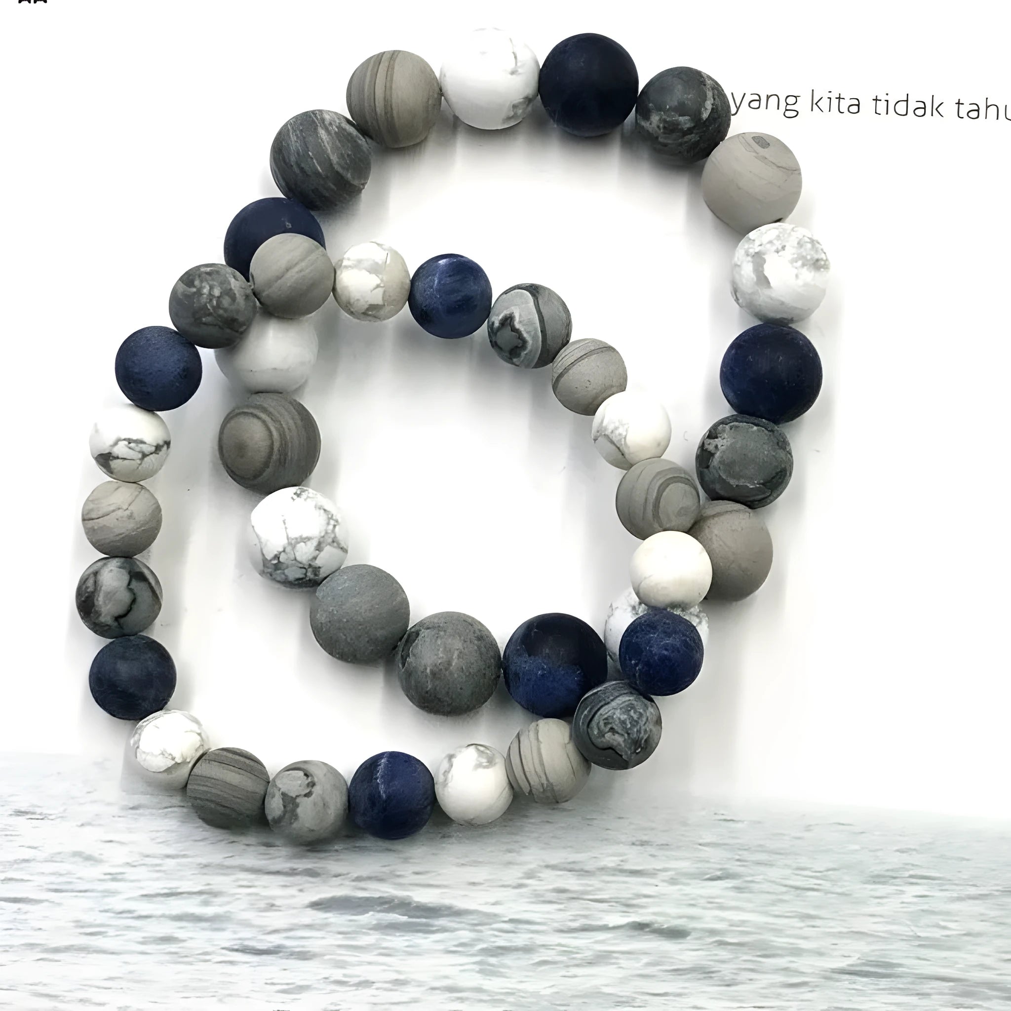 Handmade planet stone U-shaped bracelet with universe wind design on a wrist.