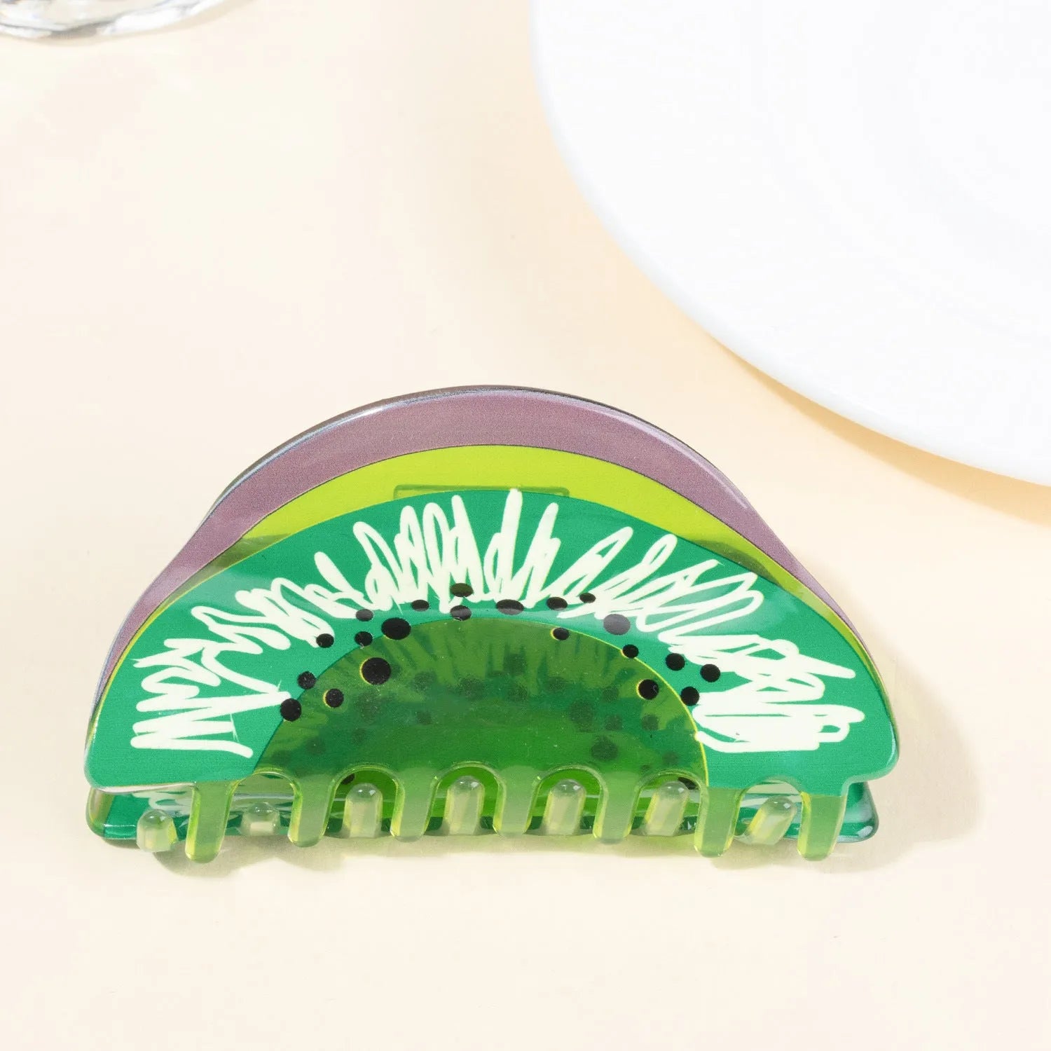 Korean creative fruit transparent PVC hair grip with asymmetric design on a white background