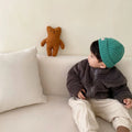 Child wearing a blue sherpa fleece zip-front winter coat with a high collar and front pockets.