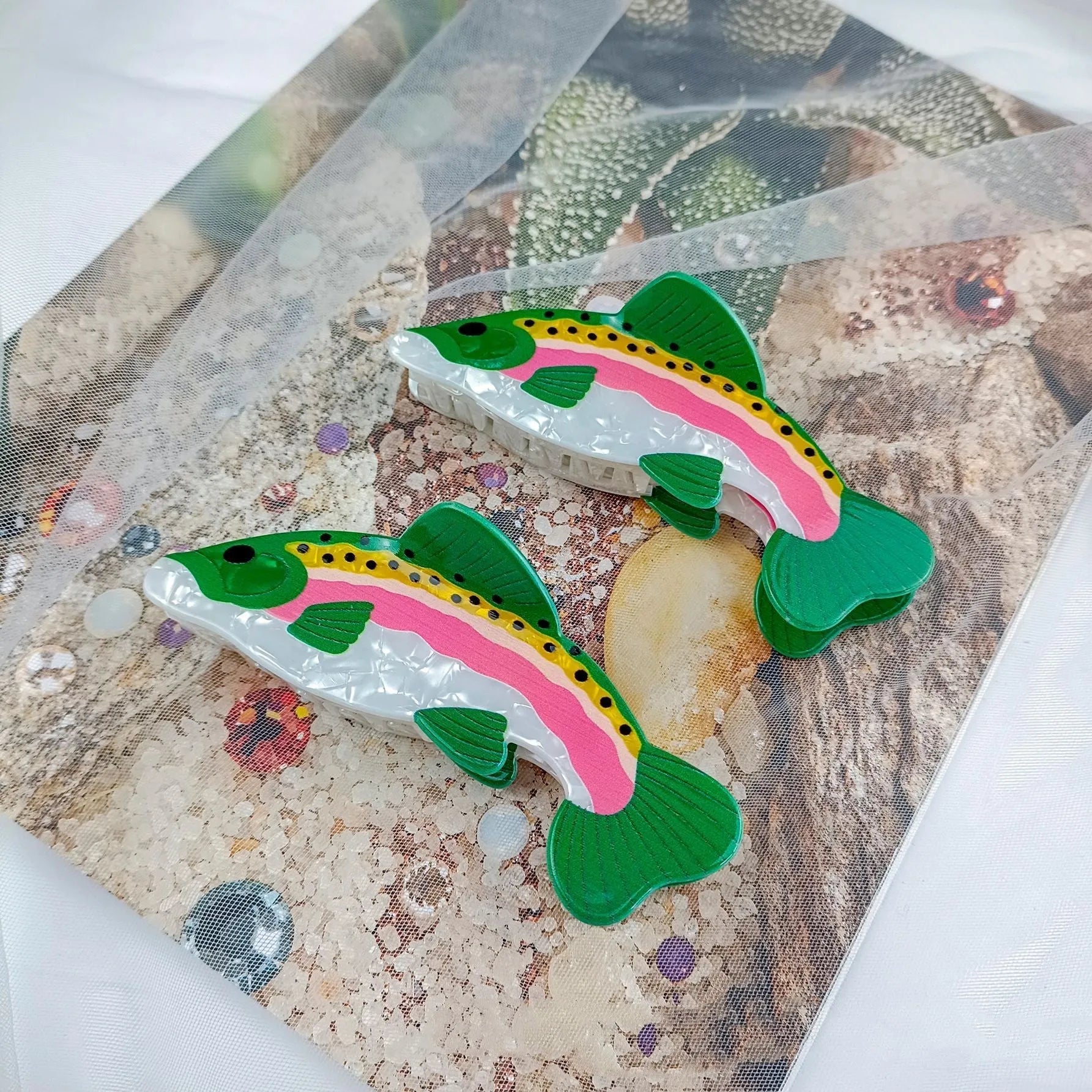 Dark green PVC hair clip with a printed design of a rainbow trout and a carp.