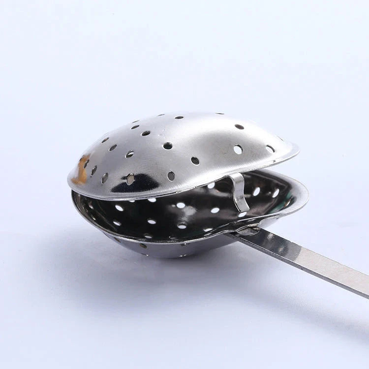 Heart-shaped stainless steel tea infuser with chain, perfect for steeping loose-leaf teas and spices