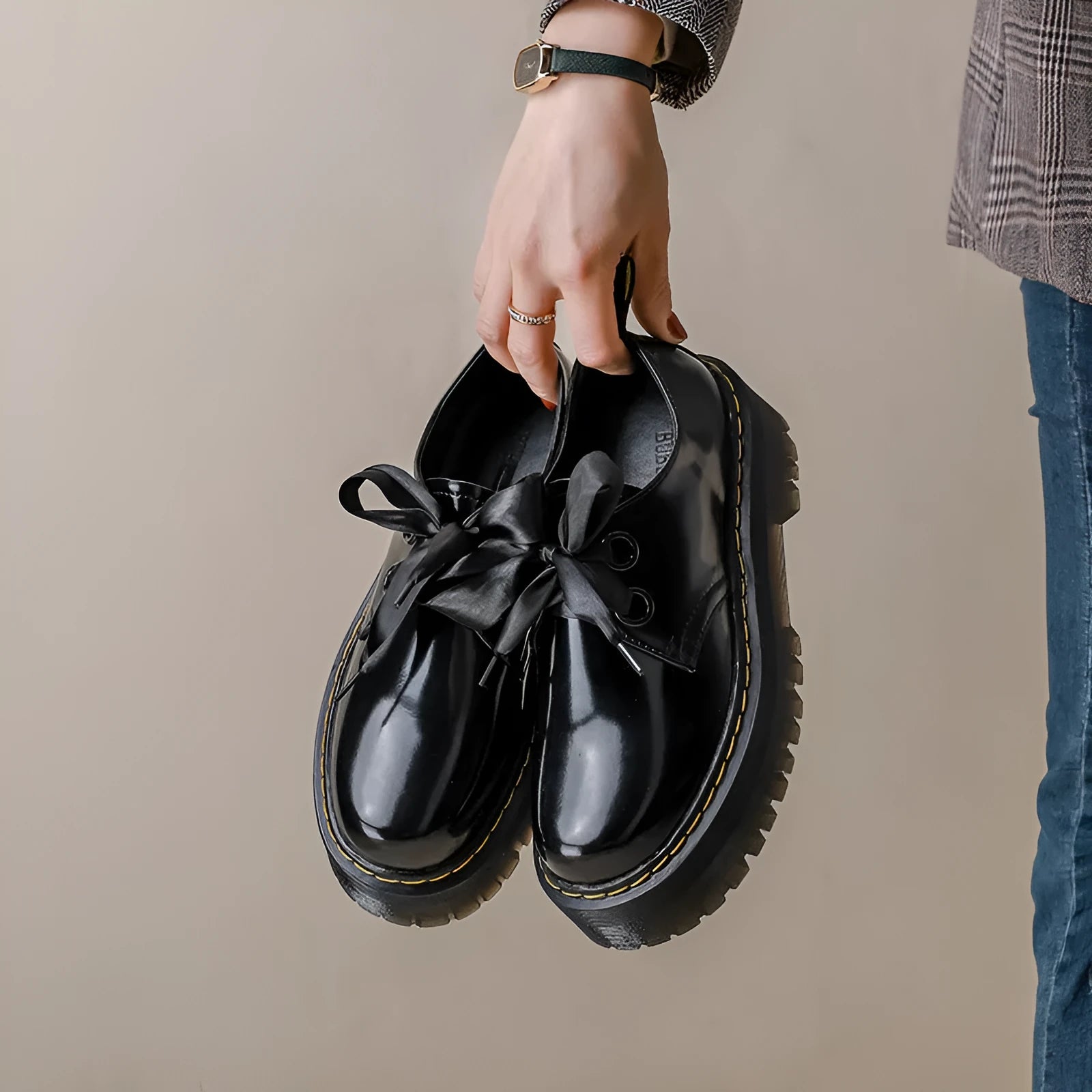 Black and white women's thick-soled small leather shoes with lace-up closure, ribbons, and cross straps.