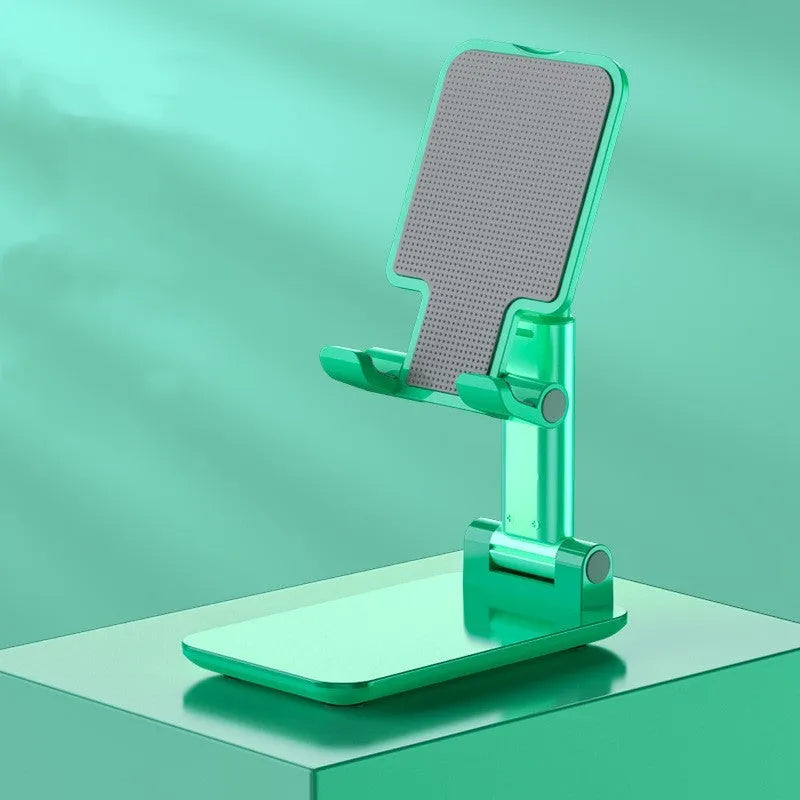 Folding telescopic mobile phone stand in white, blue, green, or pink on a desktop