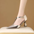 Women's silver sandals with a hollowed leather upper and pointed toe on a white background.