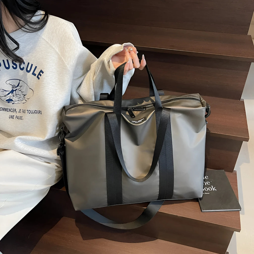 Lightweight Oxford cloth tote bag in black colour with 20-35L capacity for travel storage