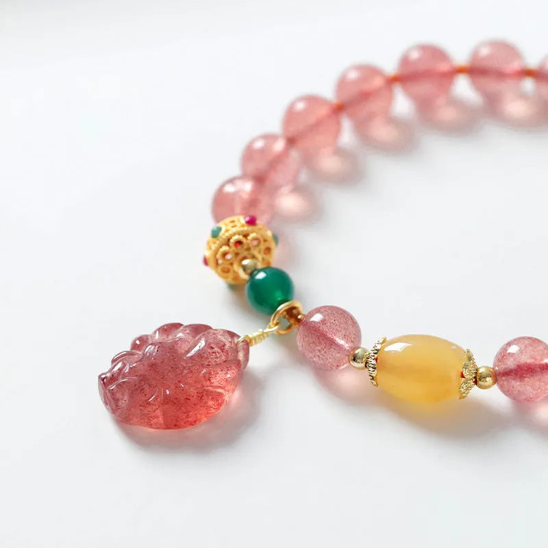 Polished crystal strawberry quartz beaded bracelet in a Nine Tail Fox style for women.